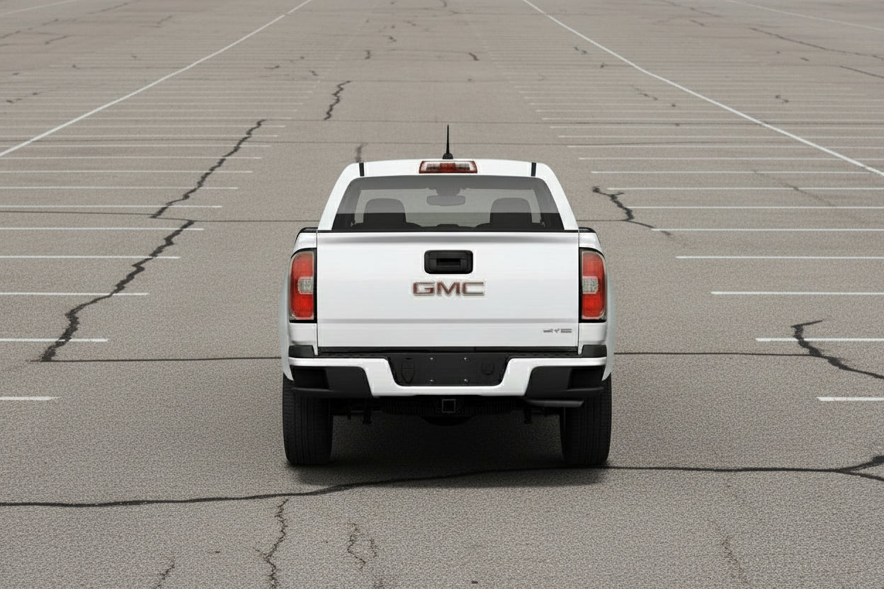 Back view of a white GMC truck on a light gray background